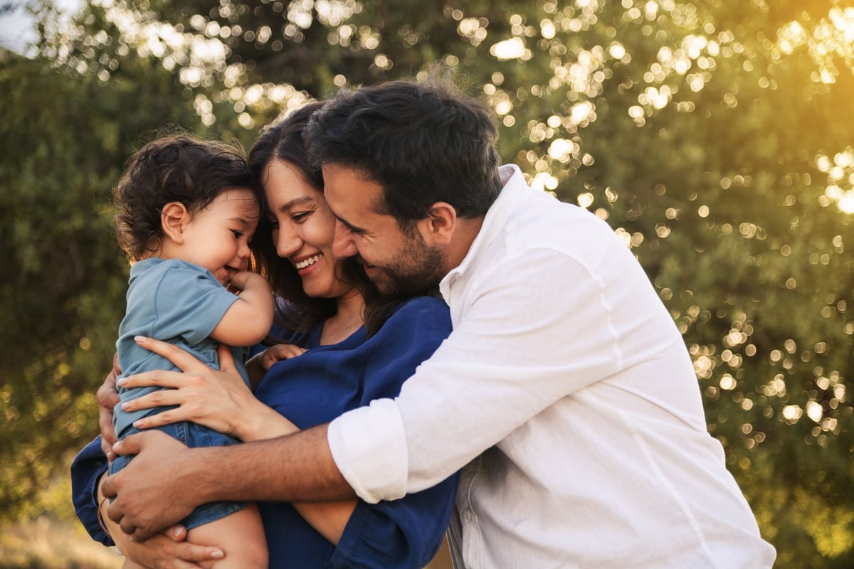 A joyful family hugging and smiling