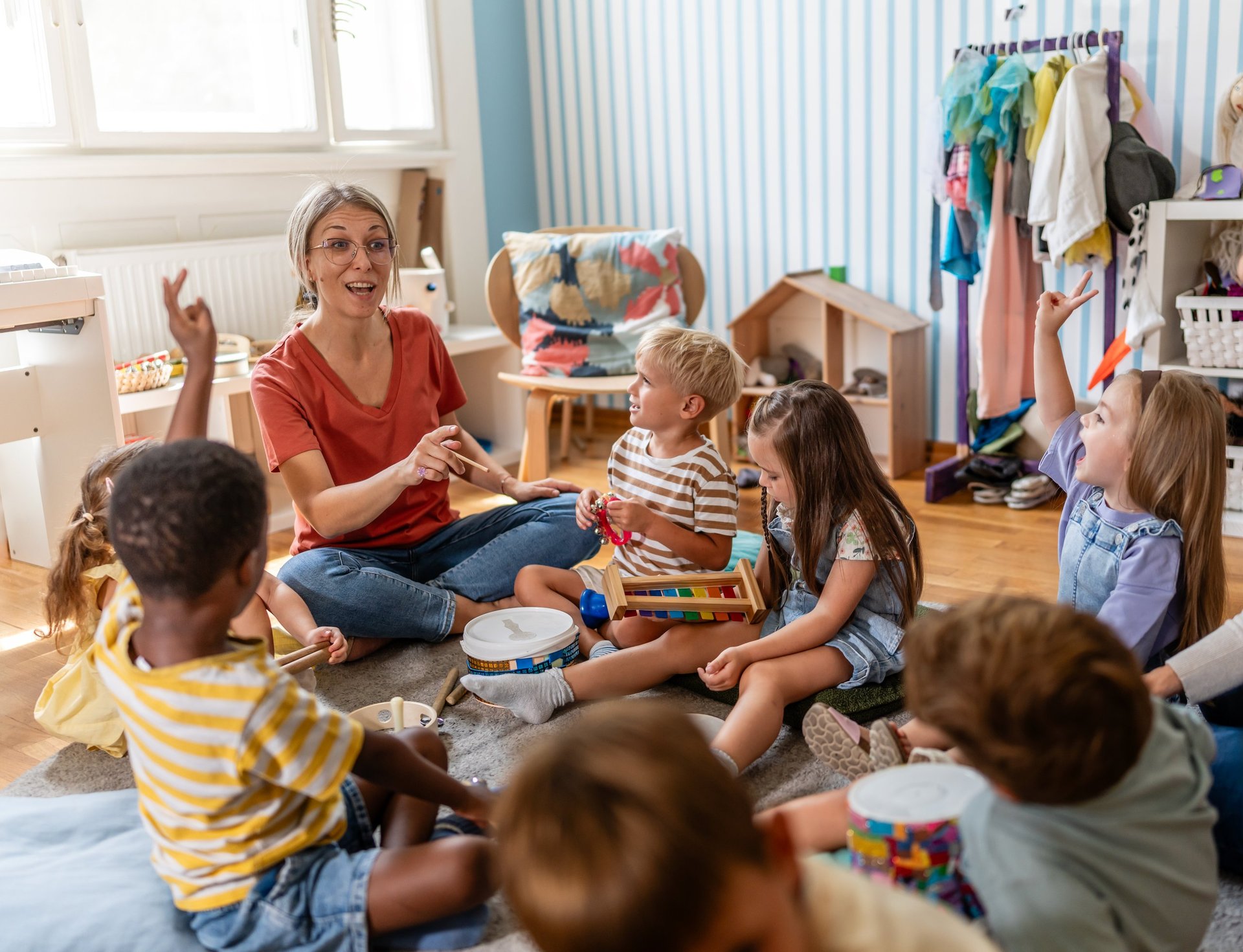Teacher engaging children in a cozy kindergarten classroom